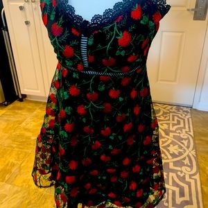 Lace black dress with embroidered flowers.